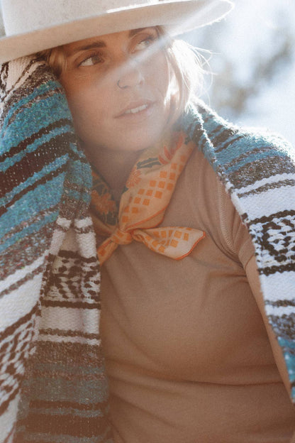 The Prickly Pollinators Bandana by Bandits Bandanas features original artwork by Zaine Vaun and celebrates the desert as a vibrant, living ecosystem. Made from GOTS-certified organic cotton and handcrafted in a Fair Trade Certified facility, this ultra-soft 21" × 21" bandana is perfect for styling in your hair, around your neck, or tied to a favorite bag. Each purchase gives back, with 10% of proceeds supporting Big Bend Conservation Alliance.