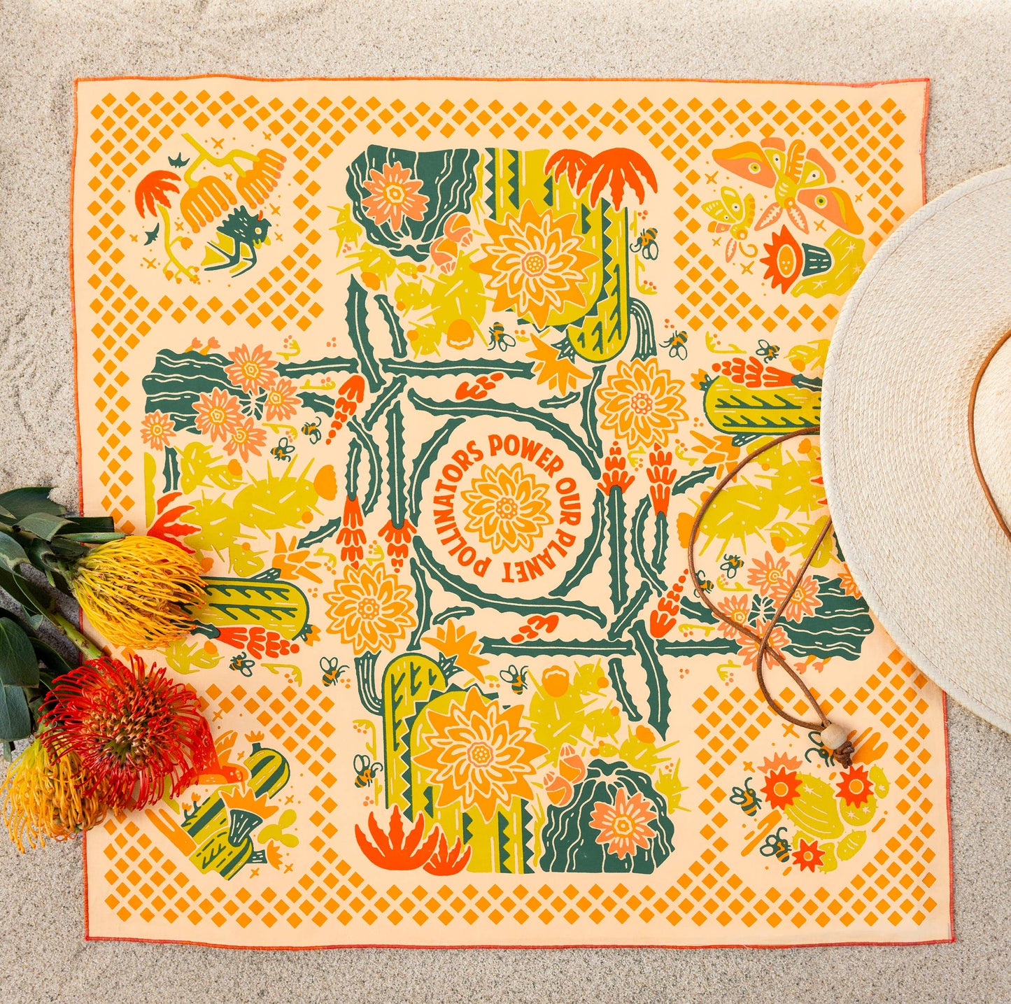 The Prickly Pollinators Bandana by Bandits Bandanas features original artwork by Zaine Vaun and celebrates the desert as a vibrant, living ecosystem. Made from GOTS-certified organic cotton and handcrafted in a Fair Trade Certified facility, this ultra-soft 21" × 21" bandana is perfect for styling in your hair, around your neck, or tied to a favorite bag. Each purchase gives back, with 10% of proceeds supporting Big Bend Conservation Alliance.