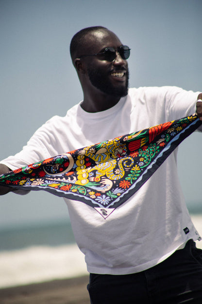 The Tropic Like It’s Hot Bandana by Bandits Bandanas features original artwork by Joshua Noom and is crafted from GOTS-certified, Fair Trade Certified organic cotton. Soft, breathable, and easy to style, this 21" × 21" bandana is perfect for everyday wear—at the neck, in the hair, or tied to a favorite bag. Each purchase gives back, with 10% of proceeds supporting American Red Cross Hurricane Relief, making it a vibrant, artist-driven accessory with meaningful impact.