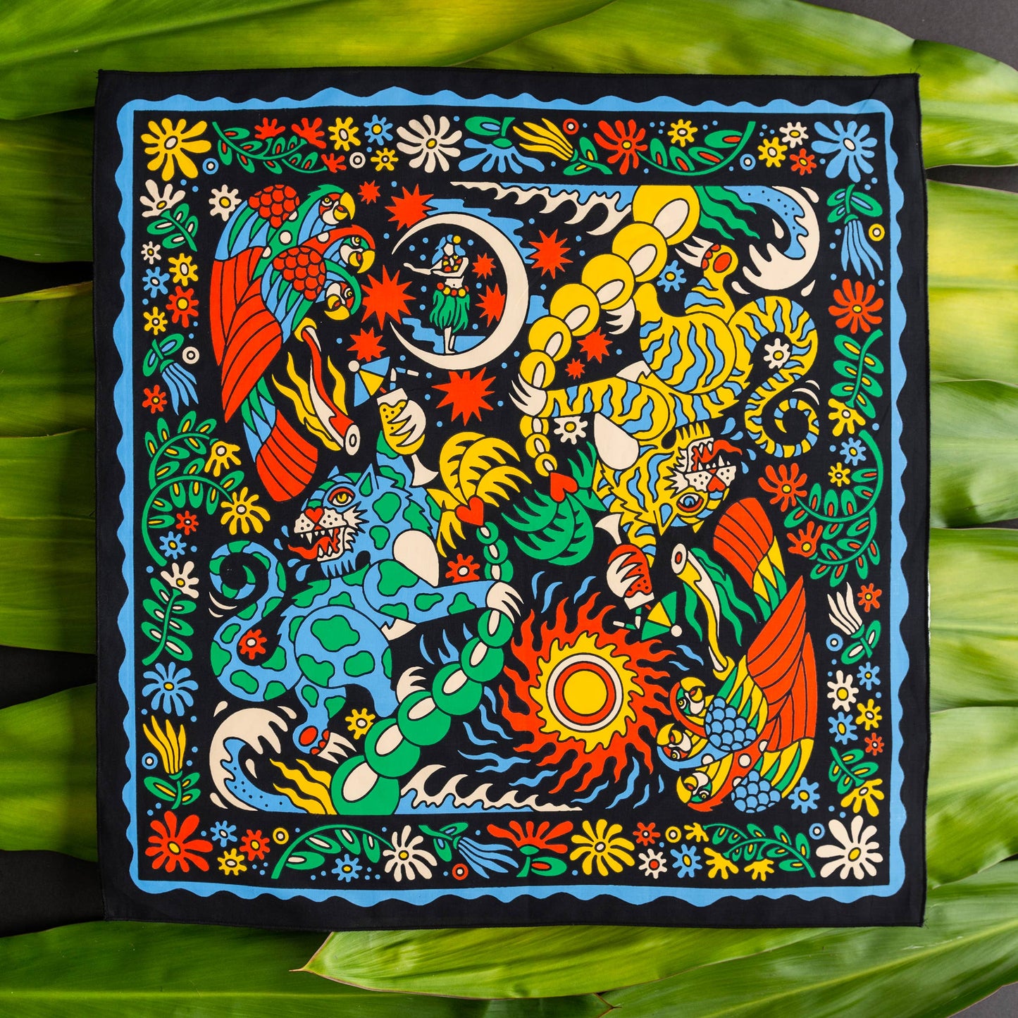 The Tropic Like It’s Hot Bandana by Bandits Bandanas features original artwork by Joshua Noom and is crafted from GOTS-certified, Fair Trade Certified organic cotton. Soft, breathable, and easy to style, this 21" × 21" bandana is perfect for everyday wear—at the neck, in the hair, or tied to a favorite bag. Each purchase gives back, with 10% of proceeds supporting American Red Cross Hurricane Relief, making it a vibrant, artist-driven accessory with meaningful impact.