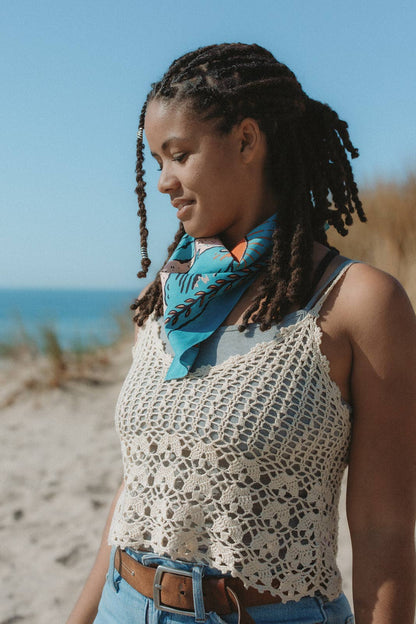 The Volcano and Sea Bandana by Bandits Bandanas features original artwork by Indonesian artist Fahrenno Asnawan. Made from Fair Trade Certified, 100% organic cotton, this soft, artist-designed bandana is perfect for styling at the neck, in the hair, or on a favorite bag. Each purchase gives back, with 10% of proceeds supporting Wahli Indonesia, making it a meaningful accessory rooted in art, ethics, and everyday wear.