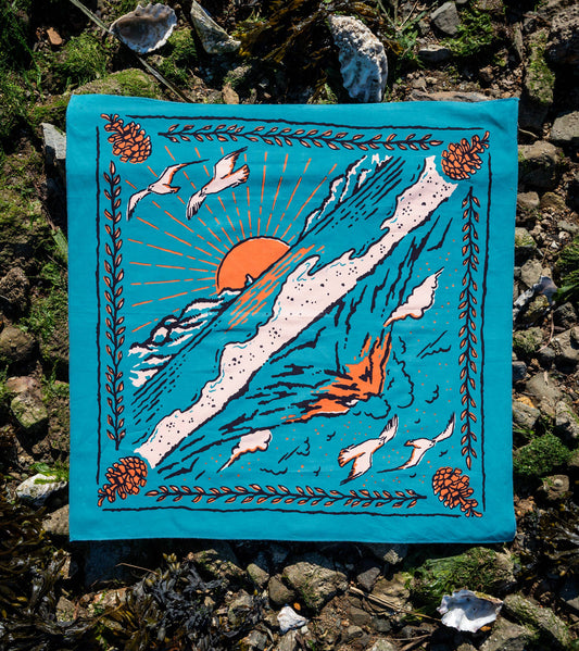 The Volcano and Sea Bandana by Bandits Bandanas features original artwork by Indonesian artist Fahrenno Asnawan. Made from Fair Trade Certified, 100% organic cotton, this soft, artist-designed bandana is perfect for styling at the neck, in the hair, or on a favorite bag. Each purchase gives back, with 10% of proceeds supporting Wahli Indonesia, making it a meaningful accessory rooted in art, ethics, and everyday wear.