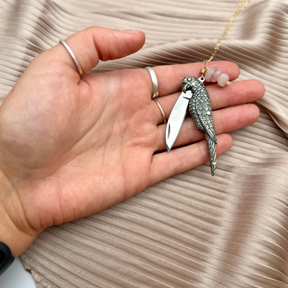 The Polly Necklace by Fluff Hardware is a handcrafted sterling silver necklace featuring a parrot-inspired functional utility charm paired with natural rose quartz nugget beads. Designed for intentional, empowered wear, this small-batch piece blends symbolic jewelry with practical design. Finished on a hypoallergenic sterling silver chain, it’s a meaningful accessory for those drawn to artisan craftsmanship and purpose-driven adornment.