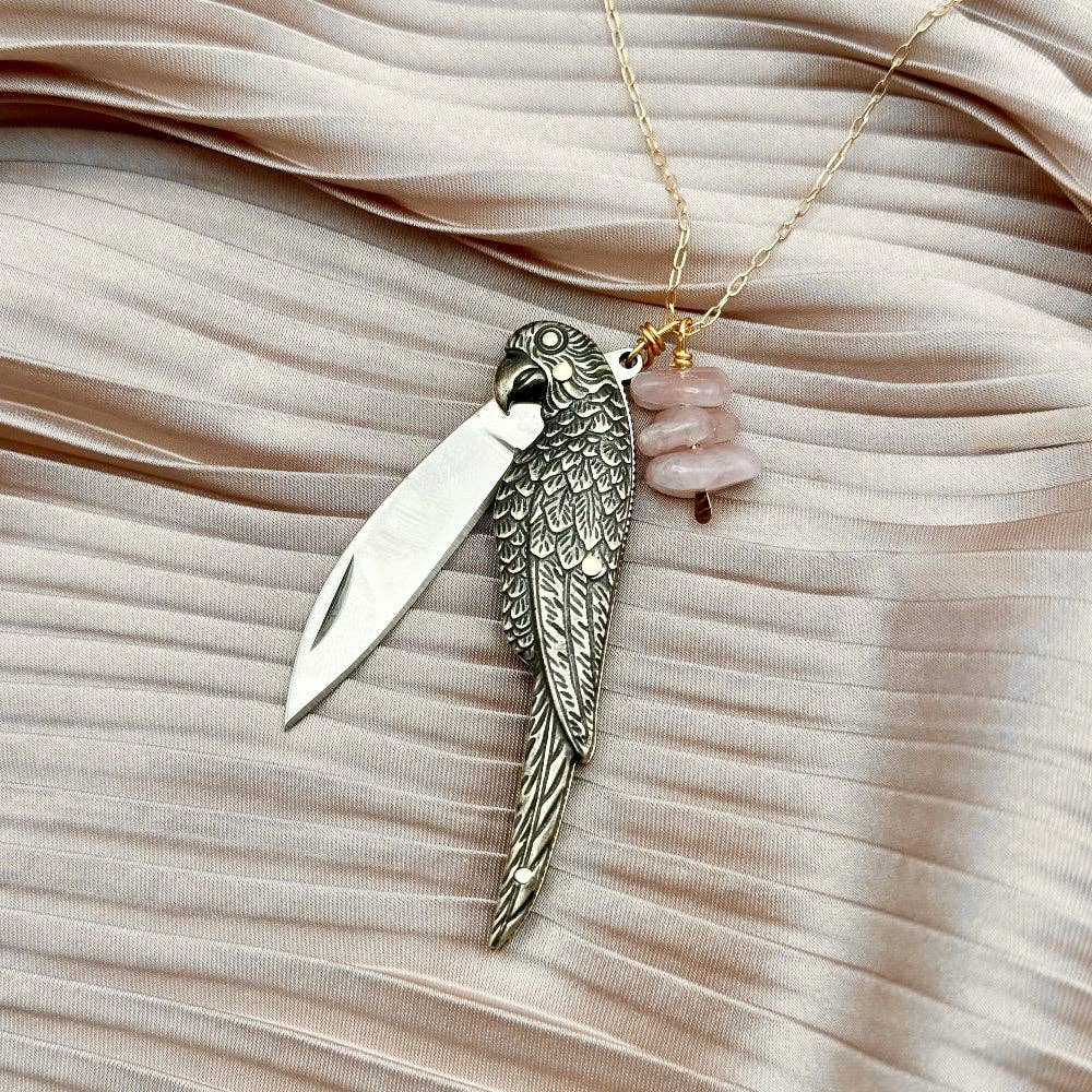 The Polly Necklace by Fluff Hardware is a handcrafted sterling silver necklace featuring a parrot-inspired functional utility charm paired with natural rose quartz nugget beads. Designed for intentional, empowered wear, this small-batch piece blends symbolic jewelry with practical design. Finished on a hypoallergenic sterling silver chain, it’s a meaningful accessory for those drawn to artisan craftsmanship and purpose-driven adornment.