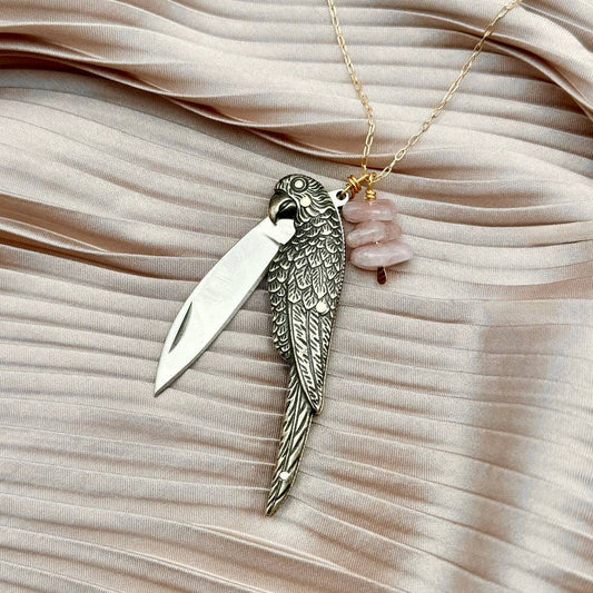 The Polly Necklace by Fluff Hardware is a handcrafted sterling silver necklace featuring a parrot-inspired functional utility charm paired with natural rose quartz nugget beads. Designed for intentional, empowered wear, this small-batch piece blends symbolic jewelry with practical design. Finished on a hypoallergenic sterling silver chain, it’s a meaningful accessory for those drawn to artisan craftsmanship and purpose-driven adornment.