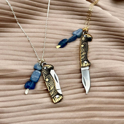 The Talon Necklace by Fluff Hardware is a handcrafted gold-filled necklace featuring an eagle-inspired functional talon utility charm accented with natural kyanite beads. Designed for intentional wear, this mixed-use piece blends symbolic jewelry with practical design. Finished with a hypoallergenic 14k gold filled chain, it’s a bold, meaningful accessory for those drawn to empowered, purpose-driven adornment.