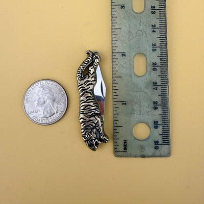 The Untamed Necklace by Fluff Hardware is a handcrafted gold-filled necklace featuring a tiger-inspired functional utility charm accented with natural turquoise nugget beads. Designed for empowered, intentional wear, this small-batch piece blends symbolic jewelry with practical design. Finished on a hypoallergenic 14k gold filled chain, it’s a striking accessory for those drawn to bold craftsmanship and purpose-driven adornment.