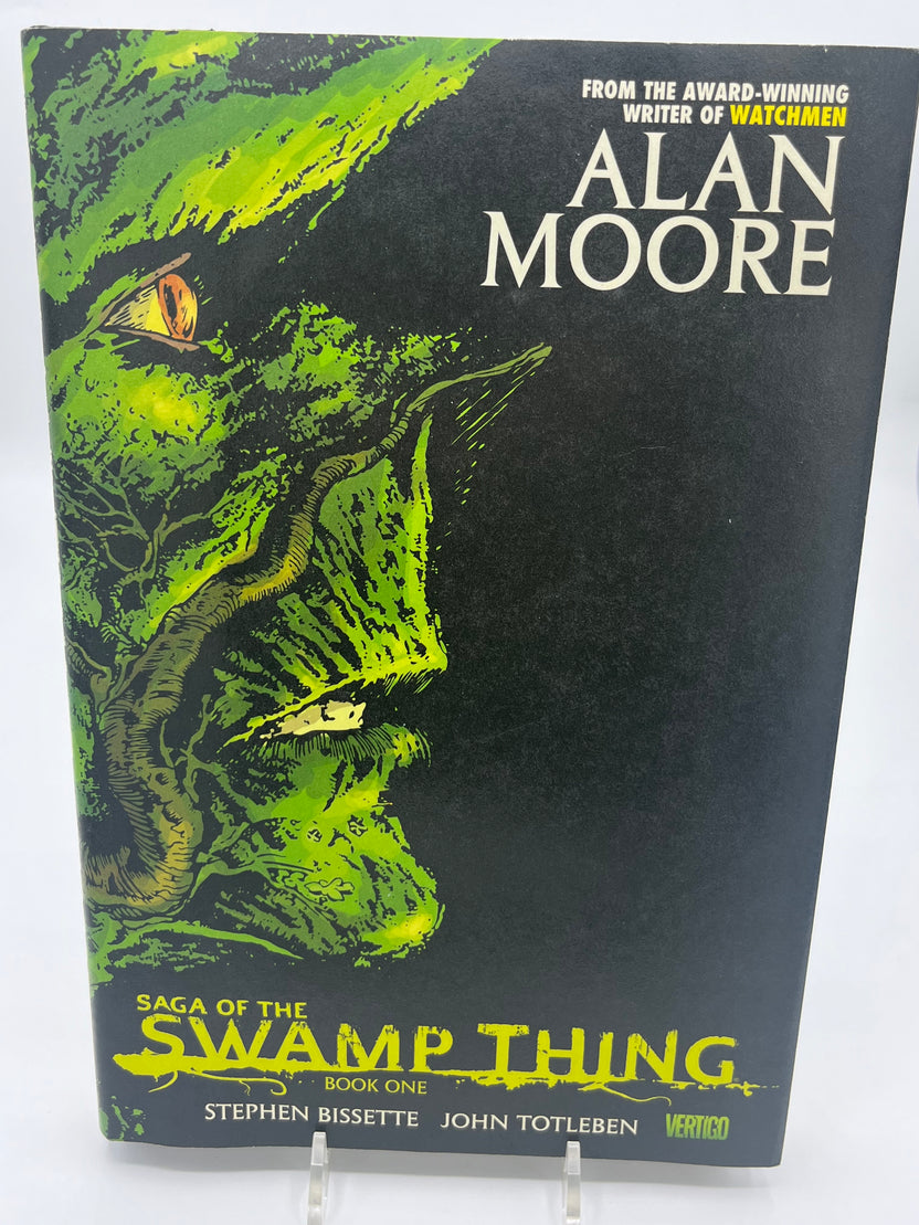 Preowned Like New hardcover edition of Saga of the Swamp Thing, Book One from Vertigo, featuring art by Stephen R. Bissette and John Totleben, with early issues written by Alan Moore. This collectible hardcover is a foundational horror graphic novel, perfect for fans of Vertigo comics, dark fantasy, and influential comic book storytelling.