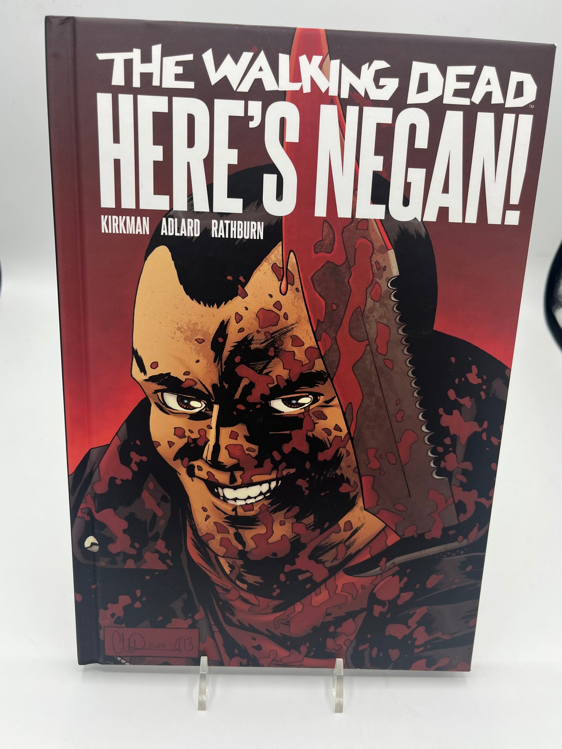 Preowned Like New hardcover edition of The Walking Dead: Here’s Negan! by Robert Kirkman with art by Charlie Adlard (Image Comics). This collectible graphic novel explores Negan’s backstory and is perfect for fans of The Walking Dead comics, horror graphic novels, and character-driven origin stories.