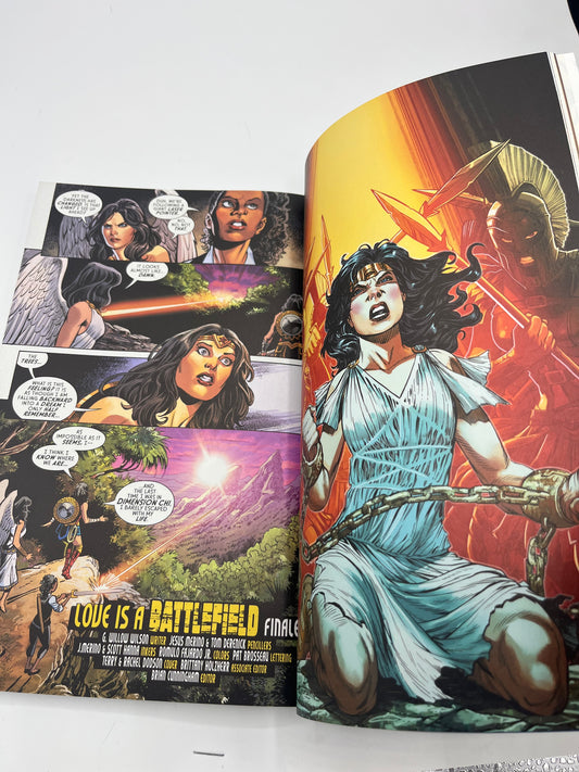 Preowned Excellent copy of Wonder Woman, Vol. 2: Love Is a Battlefield (DC), written by G. Willow Wilson with art by Cary Nord and Xermanico. Collects Wonder Woman #66–73. A strong modern Wonder Woman volume with character-driven storytelling and accessible continuity. Minor cover waviness and a bookstore barcode sticker on the back; otherwise clean and solid—great for reading or completing the run.