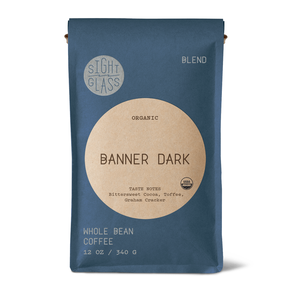 Front of Sightglass Coffee Banner Dark organic whole bean coffee 12 oz bag with tasting notes of bittersweet cocoa, toffee, and graham cracker.