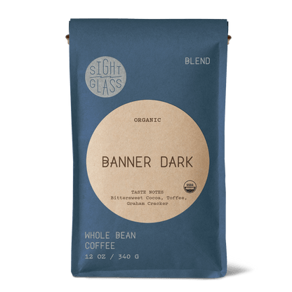 Front of Sightglass Coffee Banner Dark organic whole bean coffee 12 oz bag with tasting notes of bittersweet cocoa, toffee, and graham cracker.