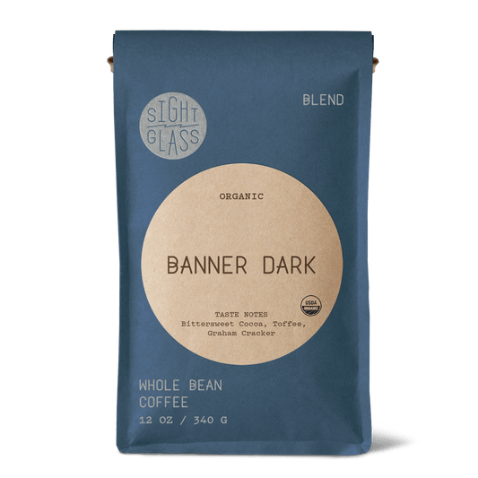 Front of Sightglass Coffee Banner Dark organic whole bean coffee 12 oz bag with tasting notes of bittersweet cocoa, toffee, and graham cracker.
