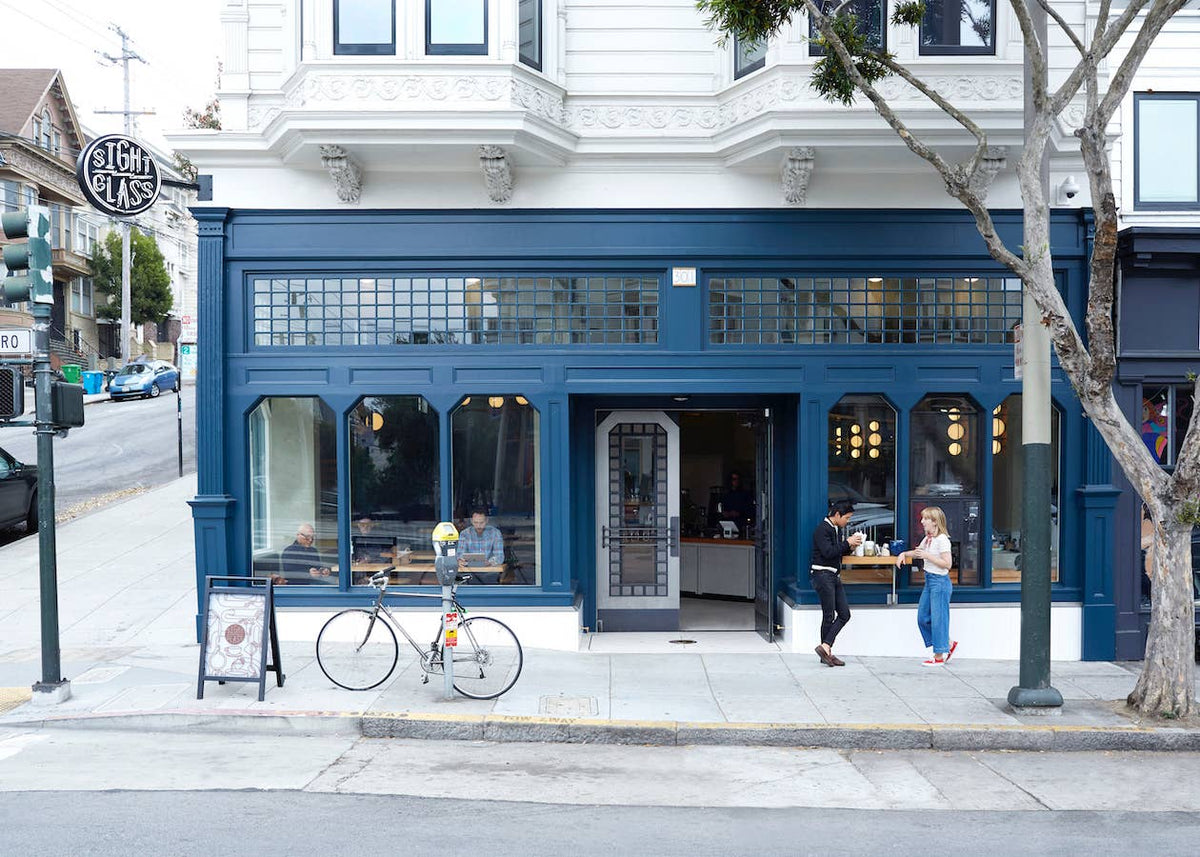 Exterior of the Sightglass Coffee café in San Francisco with customers outside the entrance.
