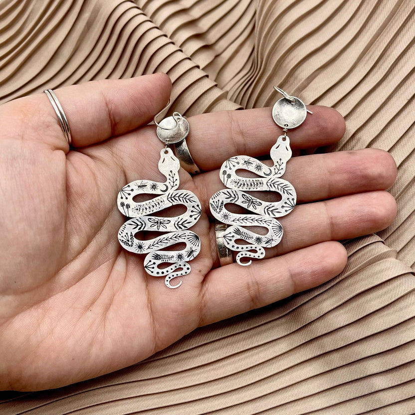 Slither, serpent and circle earrings, gold snake earrings, mythic jewelry for women, transformation symbol earrings, snake and silver earrings, mixed metal statement earrings, gold and silver dangle earrings, snake charm earrings, hypoallergenic serpent earrings, ancient symbol jewelry, ouroboros inspired earrings, spiritual transformation earrings, textured silver and gold earrings, sterling silver plated earrings, mystical boho jewelry