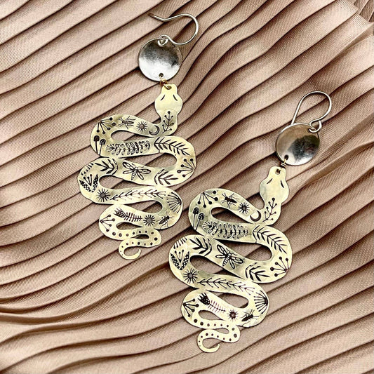 Slither, serpent and circle earrings, gold snake earrings, mythic jewelry for women, transformation symbol earrings, snake and silver earrings, mixed metal statement earrings, gold and silver dangle earrings, snake charm earrings, hypoallergenic serpent earrings, ancient symbol jewelry, ouroboros inspired earrings, spiritual transformation earrings, textured silver and gold earrings, sterling silver plated earrings, mystical boho jewelry