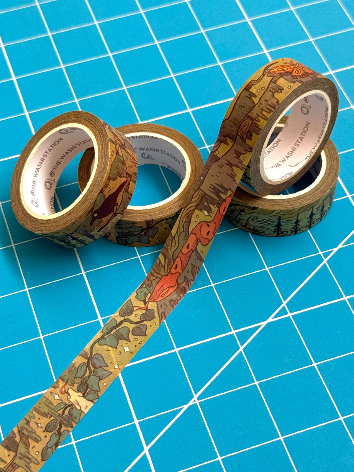 Rolls of Natalie Andrewson Southern Gothic Storyteller washi tape with illustrated tape unrolled