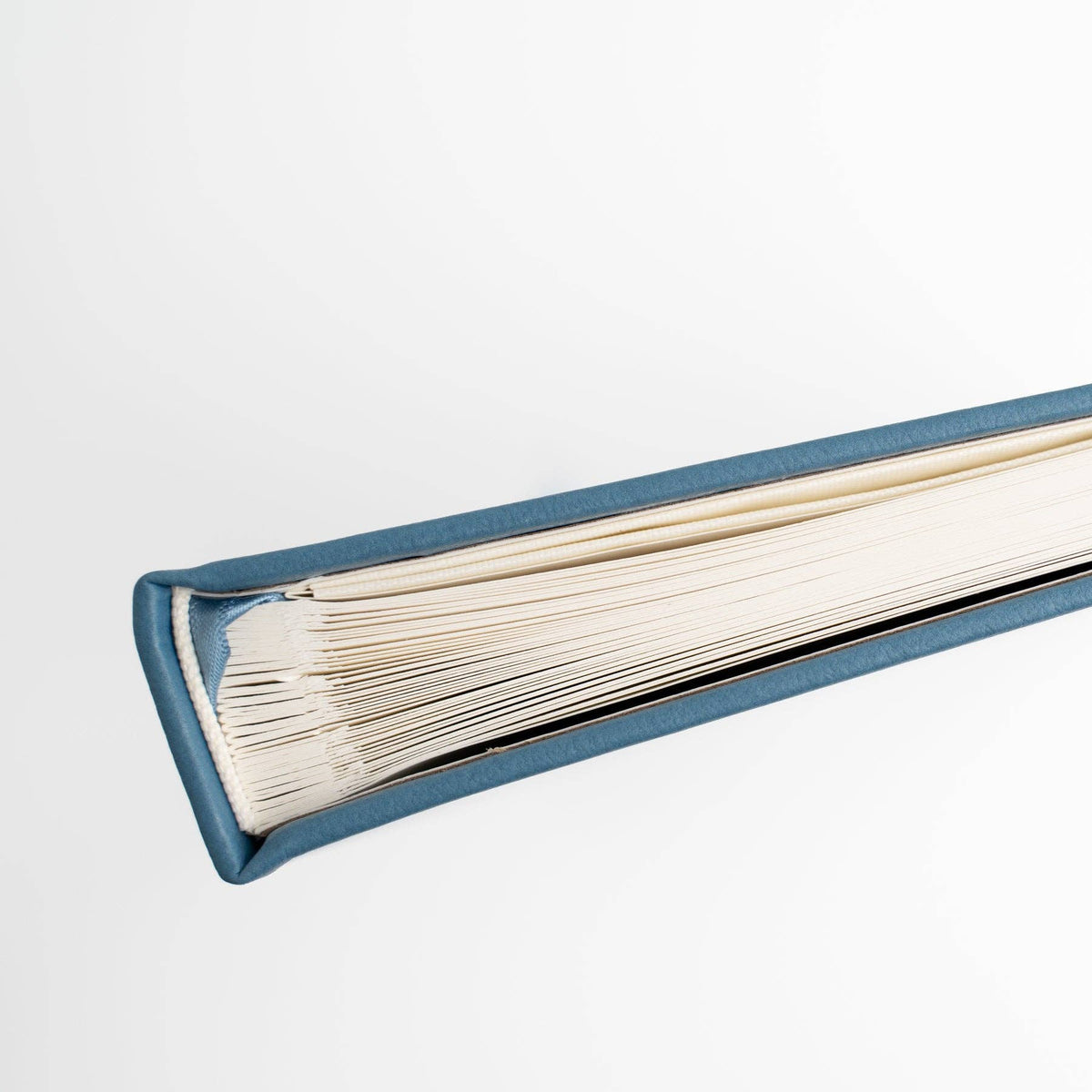 Close-up of Storybook Navy notebook binding and thick white pages
