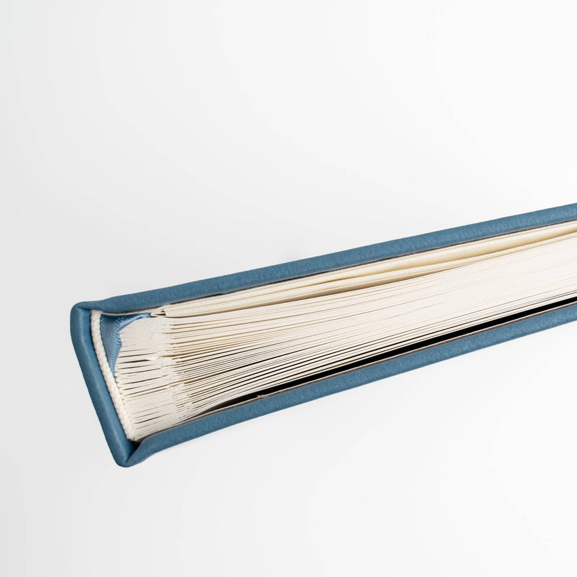 Close-up of Storybook Navy notebook binding and thick white pages