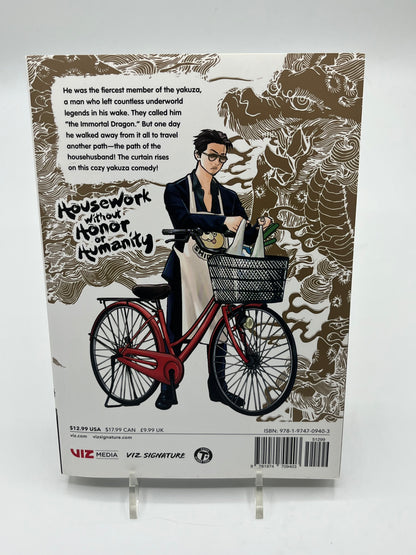 Back cover of The Way of the Househusband Volume 1 featuring Tatsu standing beside a bicycle with groceries, along with the series synopsis and publisher information.