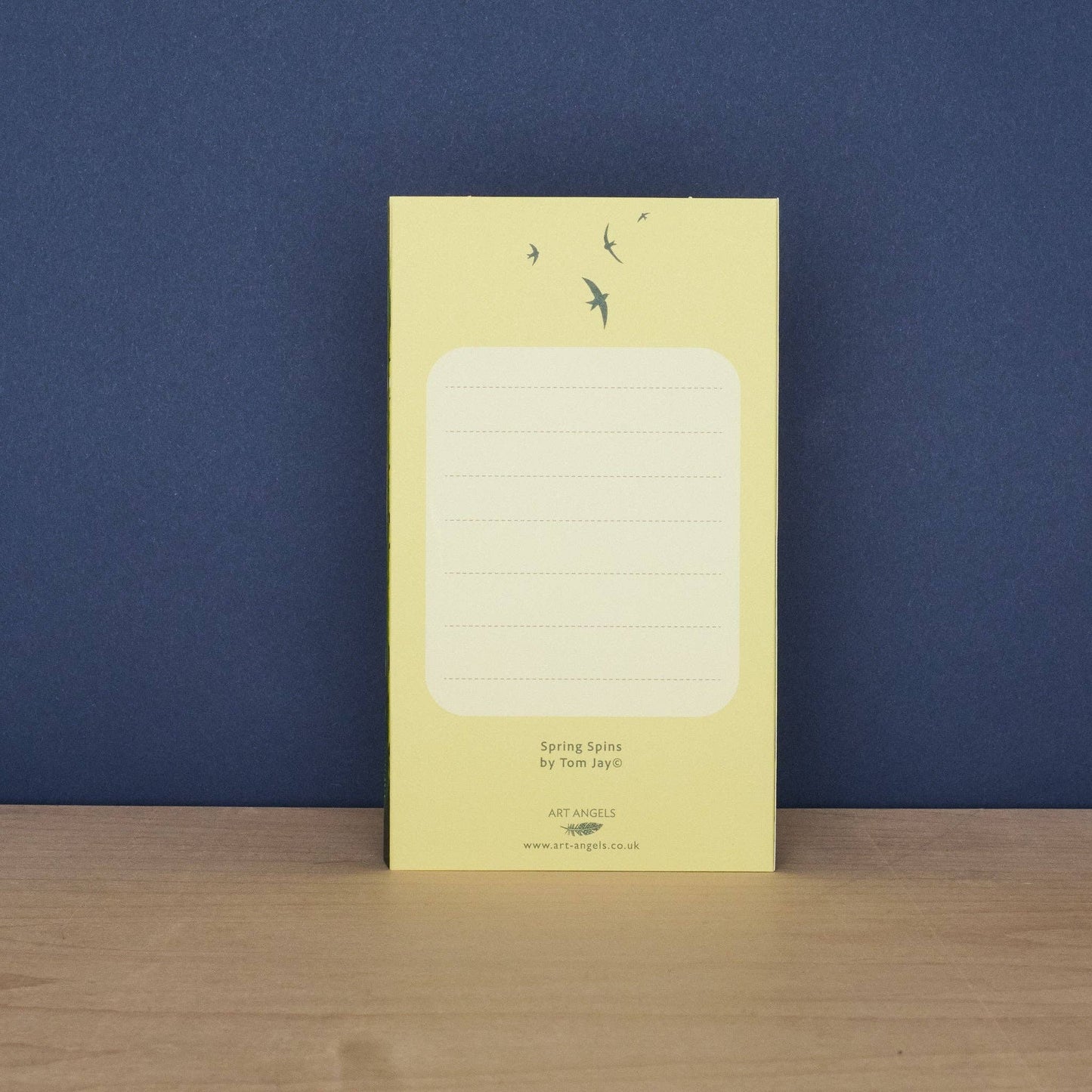 Back of the Tom Jay Spring Spins die-cut greeting card with a lined message area for writing.