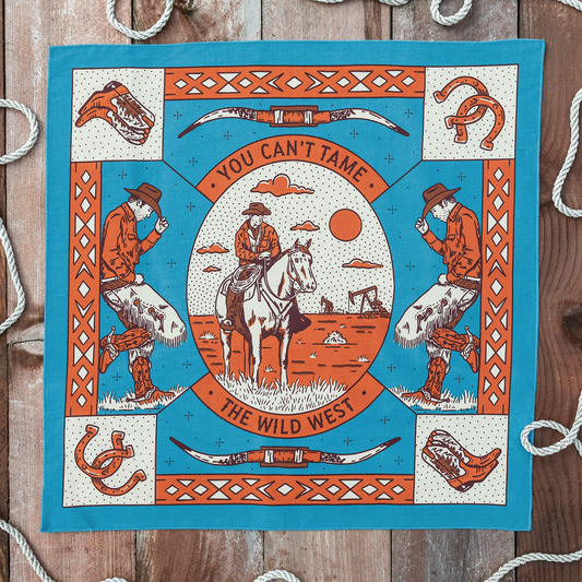 Van Berkemeyer Wild West bandana featuring a cowboy on horseback surrounded by longhorn skulls, horseshoes, cowboy boots, and bold Western-inspired illustrations.