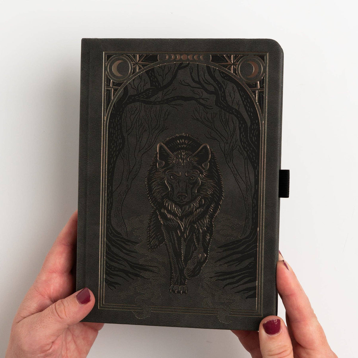 Cover of Wolf in the Night notebook with moonlit woodland design