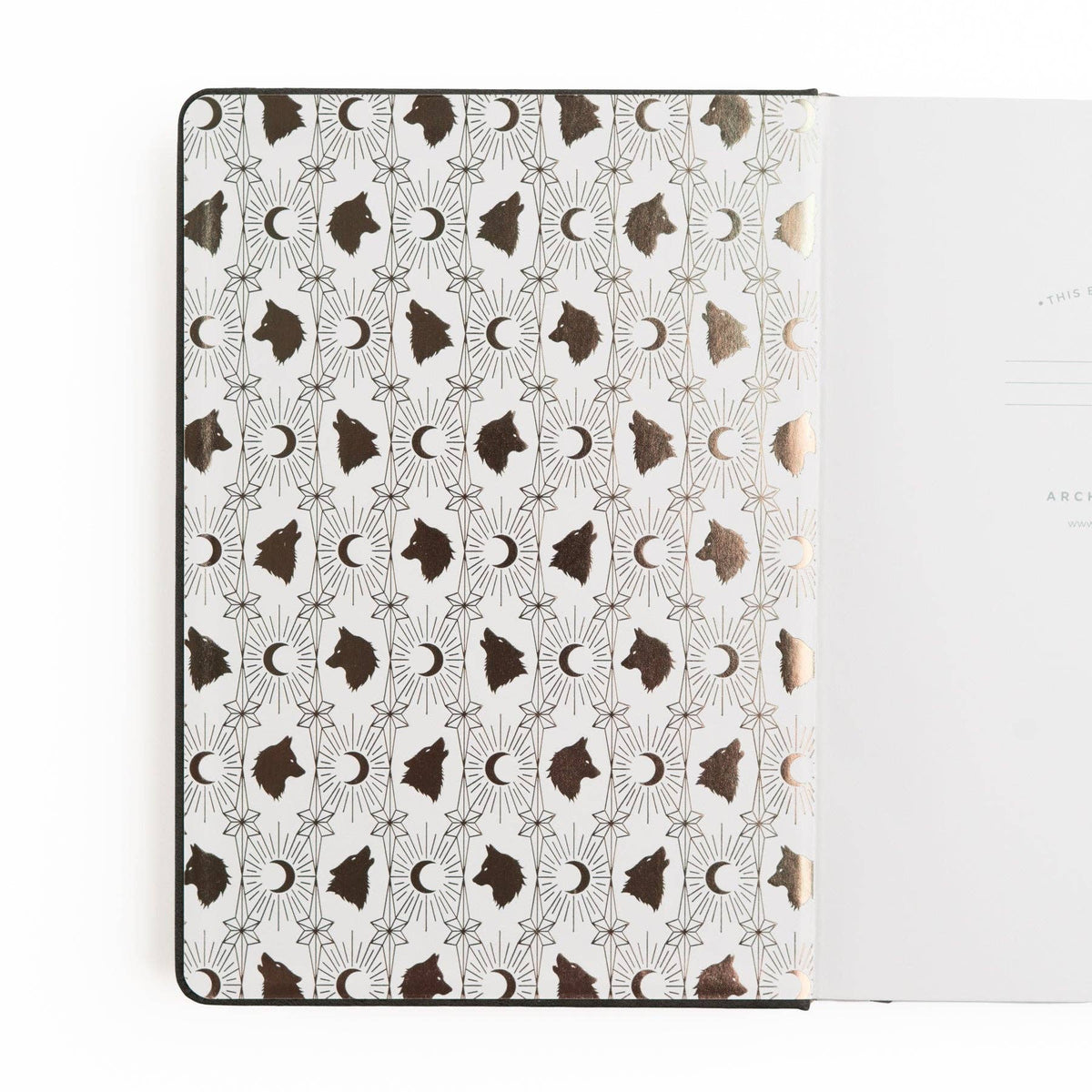 Wolf in the Night notebook open to illustrated moon and wolf endpapers