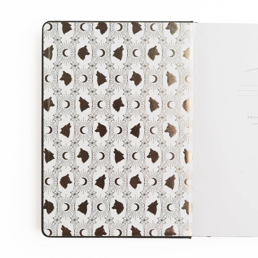 Wolf in the Night notebook open to illustrated moon and wolf endpapers