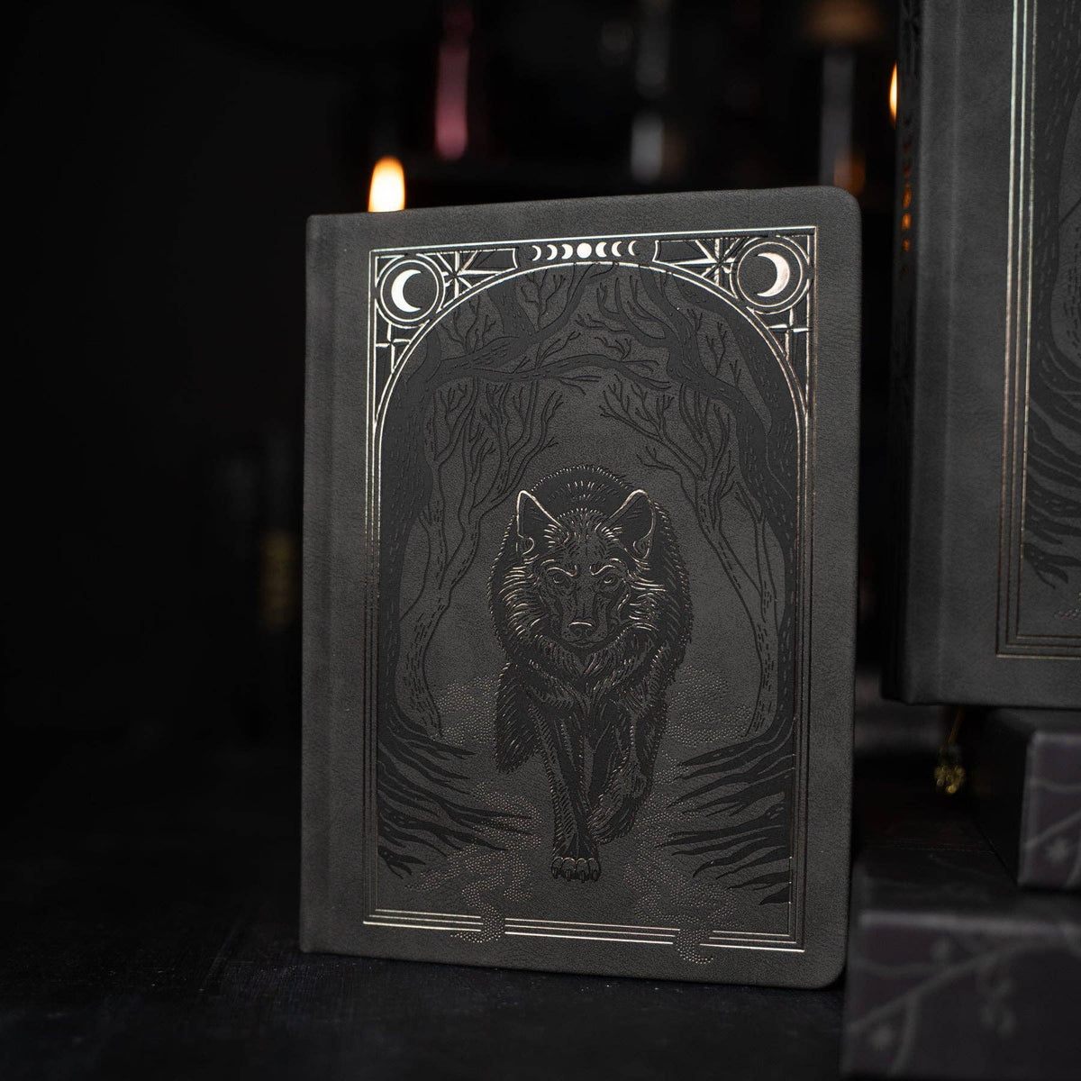 Wolf in the Night notebook photographed in low light showing reflective copper foil